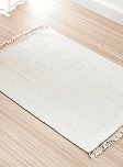 White woven rug on wooden floor