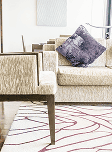 Patterned rug under a pair of chairs with cushions